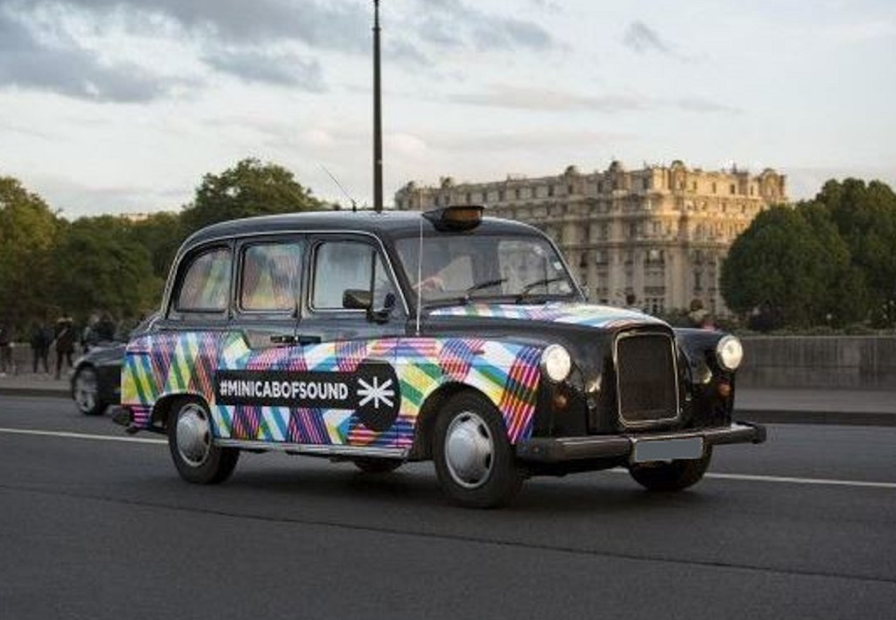 Black London taxi with a full covering #minicabofsound, Paris.